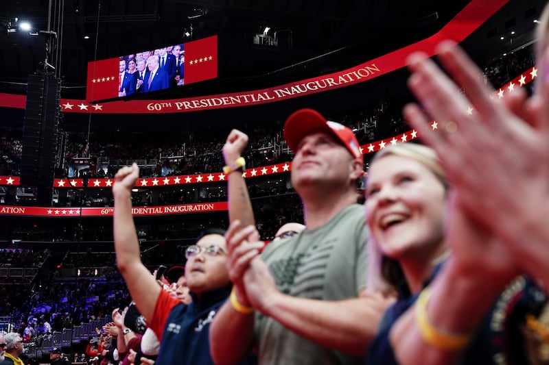 People watch President Donald Trump’s inauguration as the 47th president from Capitol One Arena in Washington on Monday. Photograph: Haiyun Jiang/The New York Times 