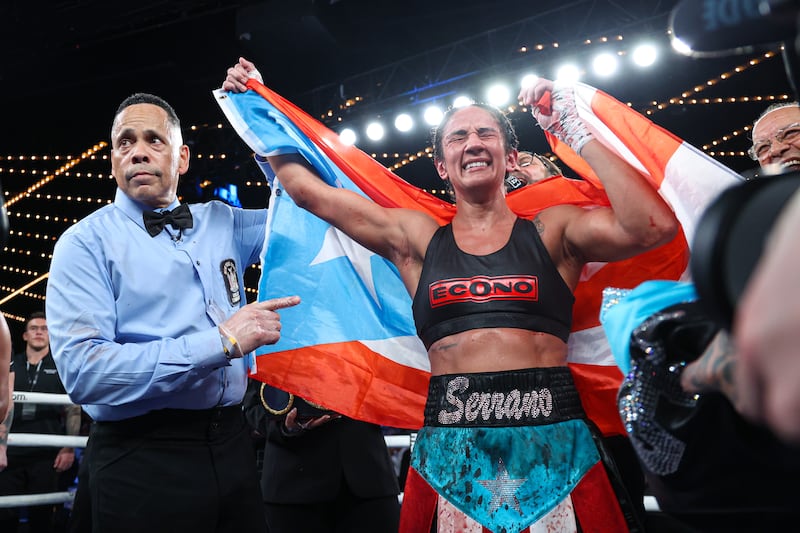 Amanda Serrano, draped in a sky blue Puerto Rican flag. celebrates her victory over Erika Cruz at Madison Square Garden, New York. Photograph: Ed Mulholland/Matchroom Boxing/Inpho
                                                                