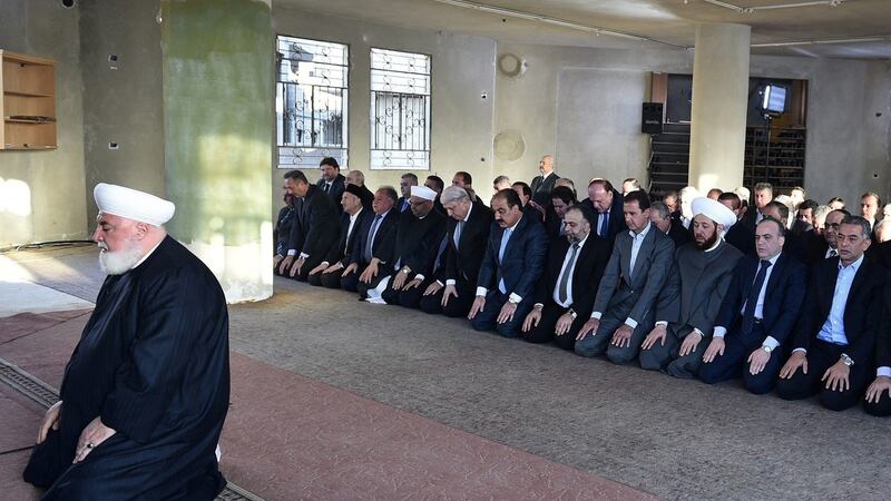 A handout picture released on the Syrian Presidency Facebook page on September 12th, 2016, shows Syrian president Bashar al-Assad (fourth from right) performing the morning prayer of the Muslim holiday of the Eid al-Adha at a mosque in a government-controlled area of Daraya. Photograph: Syrian Presidency Facebook page/AFP