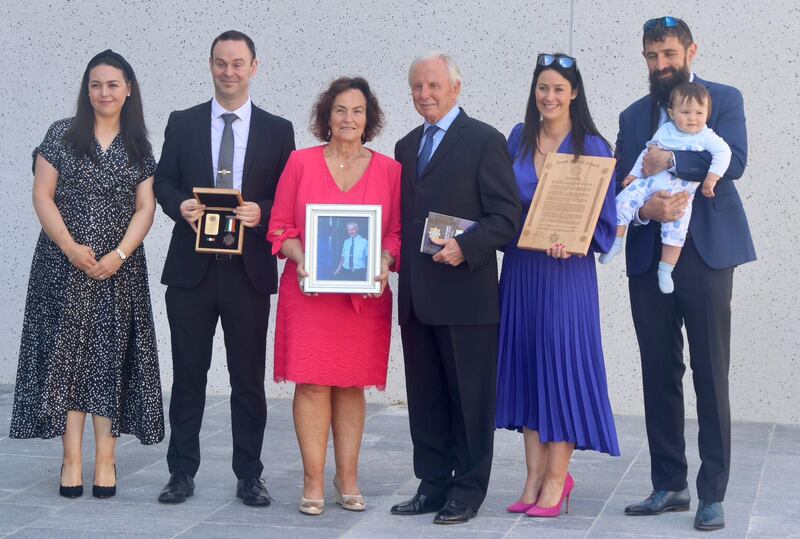 Members of Det Garda Donal Kelleher's family including his widow Caroline (centre) with Don Tidey at the Scott Medal presentation in Dublin on Friday. Det Garda Kelleher helped to rescue Mr Tidey who had been kidnapped by the Provisional IRA in 1983