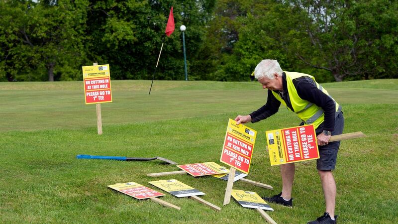 Health and safety officer Don Ponsonby erects warning signs at  Letterkenny Golf Club in Co Donegal. Photograph: Joe Dunne