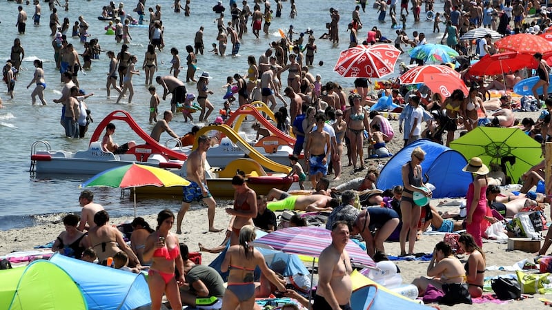 People sunbath  by the Baltic Sea at Timmendorfer Strand, Germany. Photograph: Fabian Bimmer/Reuters