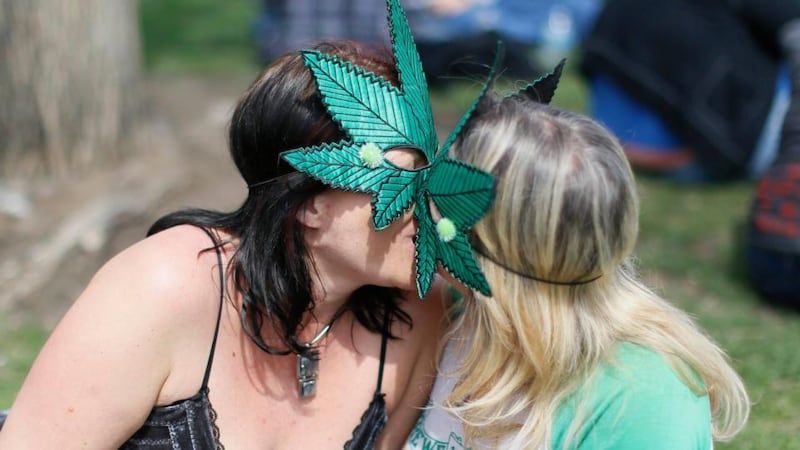 Women wearing cannabis leaf masks kiss at the 4/20 celebration in Civic Center Park in  Denver. Photograph: Rick Wilking/Reuters