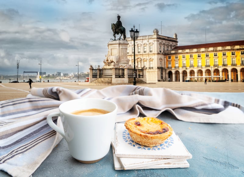 A fresh pastel de nata with coffee in Lisbon, Portugal