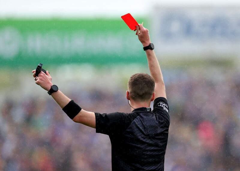 Referee Sean Stack issues a red card. Photograph: James Crombie/Inpho