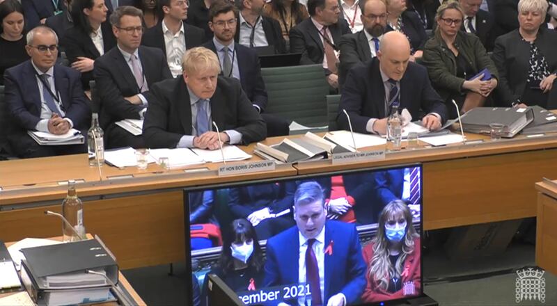 Boris Johnson  is shown footage from the House of Commons from December  as he gives evidence to the Privileges Committee at the House of Commons. Photograph: PA