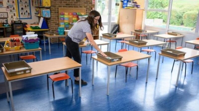 A teacher distributes individual student stationary packs ahead of the return of students to a school in London. Photograph: Leon Neal/Getty Images