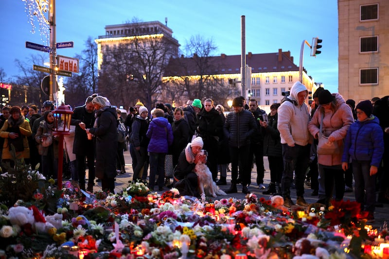 Members of the public lay flowers at the makeshift memorial near the site of the attack. Photograph: Omer Messinger/Getty Images