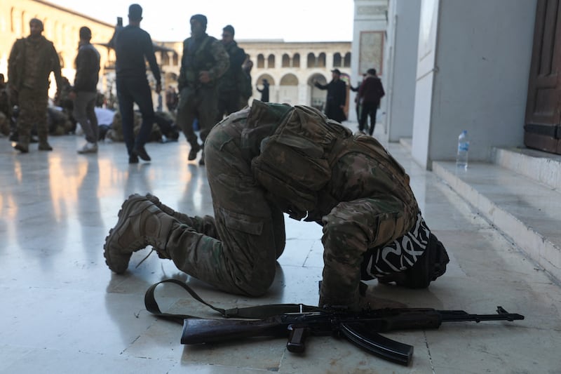 An anti-government fighter prays in the courtyard of Damascus' historic Umayyad mosque. Photograph: Abdul Ketaz/AFP/Getty Images