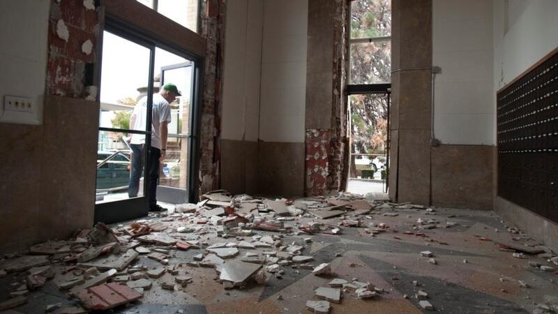 Local residents survey the damage to the historic US Post Office building in downtown Napa after a 6.1 magnitude earthquake hit the San Francisco Bay Area of Sonoma, California, early this morning. Photograph: Peter DaSilva/EPA