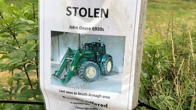 On the road into Castleblayney in Co Monaghan,  a  poster of a stolen John Deere tractor offers a reward for information about its disappearance. Photograph: Frank McNally