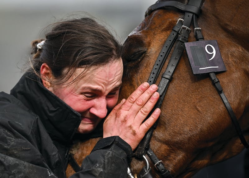 JOY: Groom Emilie Seigle and ‘Absurde’ share an emotional moment of joy after the horse won the BetMGM County Handicap Hurdle on day four of the Cheltenham Racing Festival at Prestbury Park in Cheltenham, England. Photograph: David Fitzgerald / Sportsfile
