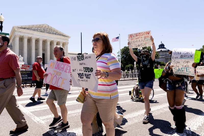 Abortion rights activists march outside the Supreme Court in Washington DC on Wednesday. Protests continue following the US Supreme Court's ruling on Dobbs v Jackson Women's Health Organization - the ruling that overturned the 1973 case of Roe v Wade which had guaranteed federal abortion rights for nearly fifty years.