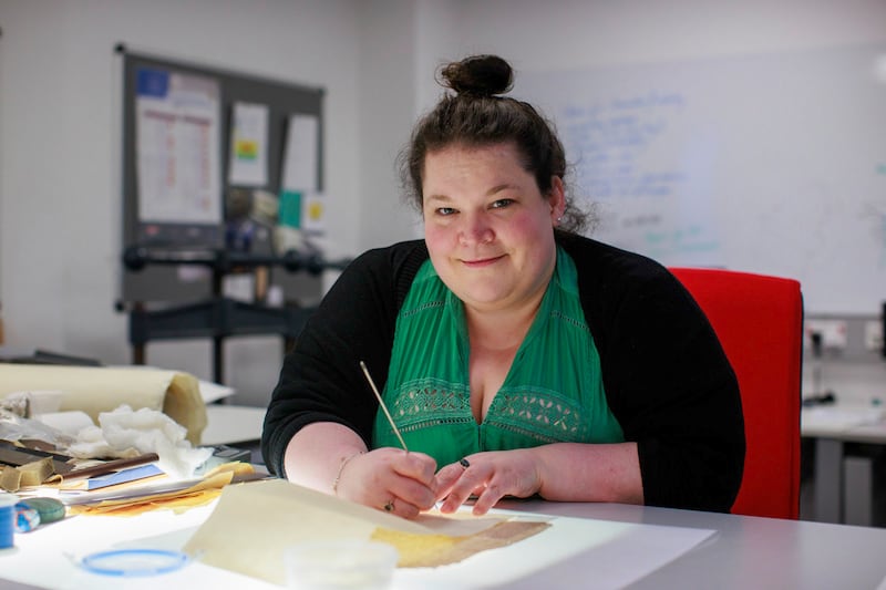 Head of conservation at Proni Sarah Graham conserving one of the oldest paper documents still in existence on the island of Ireland. Photograph: Liam McBurney/PA 