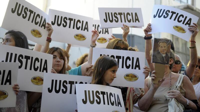 People hold placards that read “Justice” during a rally in front of the headquarters of the AMIA (Argentine Israelite Mutual Association), in Buenos Aires on January 21st, 2015, to protest against the death of Argentine public prosecutor Alberto Nisman. Photograph: Alejandro Pagni/AFP/Getty Images