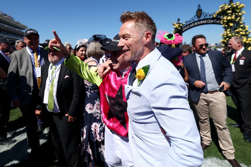 Winning jockey Robbie Dolan celebrates with Ronan Keating after winning the Melbourne Cup. Photograph: Josh Chadwick/Getty Images
