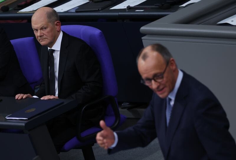 Friedrich Merz speaks as German chancellor Olaf Scholz looks on in the Bundestag on Tuesday. Photograph: Sean Gallup/Getty Images