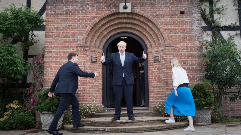 Conservative party leadership candidate Boris Johnson  gestures to visitors as two of his staff  ascend steps during a tour of the Royal Horticultural Society garden at Wisley, in Surrey. Photograph: Stefan Rousseau/PA Wire