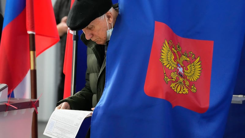 A man examines his ballot during the State Duma, the Lower House of the Russian Parliament and local parliament elections  in St. Petersburg, Russia. Photograph: Dmitri Lovetsky/AP Photo