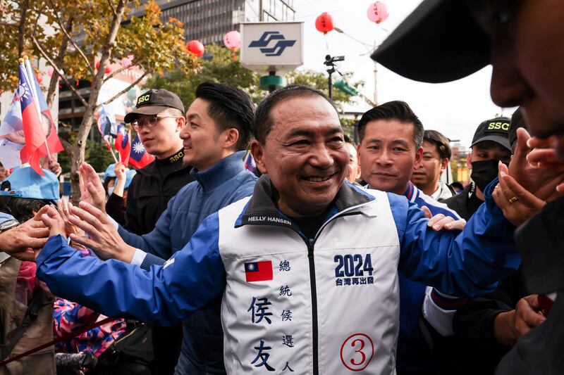 KMT presidential candidate Hou Yu-ih greets supporters while visiting a local temple in Taipei. Photograph: I-Hwa Cheng/AFP via Getty Images