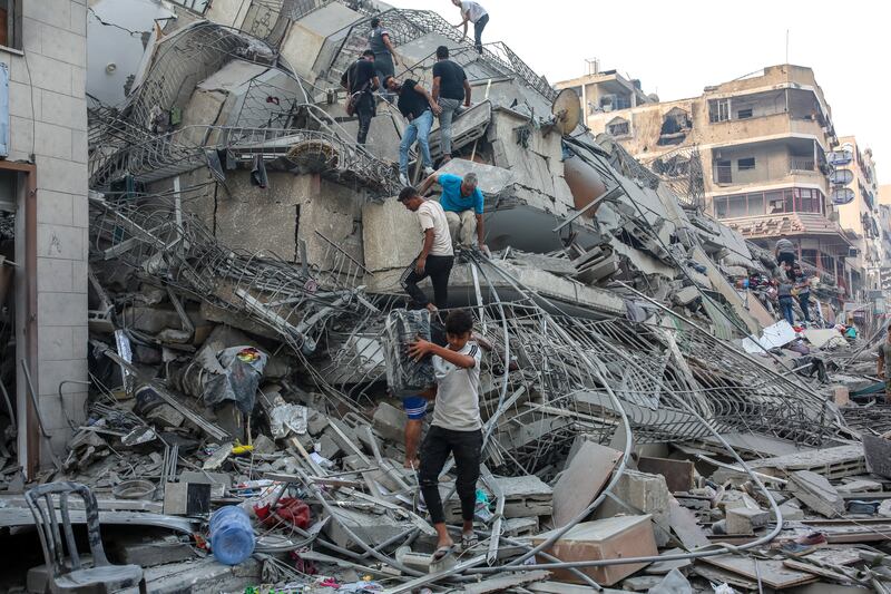 Residents inspect a damaged building after Israeli warplanes bombed Gaza City on Sunday, October 8th, 2023. Photograph: Samar Abu Elouf/The New York Times
                      