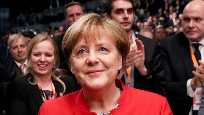 Chancellor  Merkel reacts after securing her reelection to the position of head of the party at the  convention. Photograph: Michael Kappeler/EPA