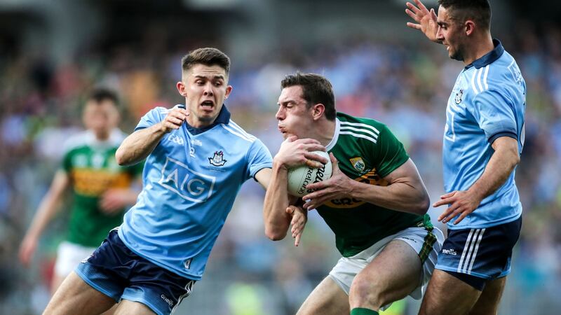 Kerry’s David Moran is challenged by  Dublin’s James McCarthy and David Byrne. Photograph: Billy Stickland/Inpho