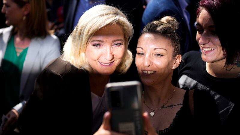 French far-right leader Marine Le Pen with a supporter: She says her foreign policy will be ‘independent’ and make of France ‘a balancing power between the two great blocks’. Photograph: Daniel Cole/AP