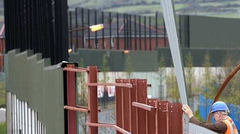 Repairing the ‘peace line’ in Belfast. Photograph: Getty Images