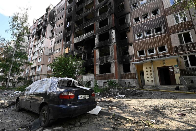 A destroyed car sits parked next to a heavily damaged residential building in Saltivka. Photograph: Genya Savilov/ AFP via Getty Images