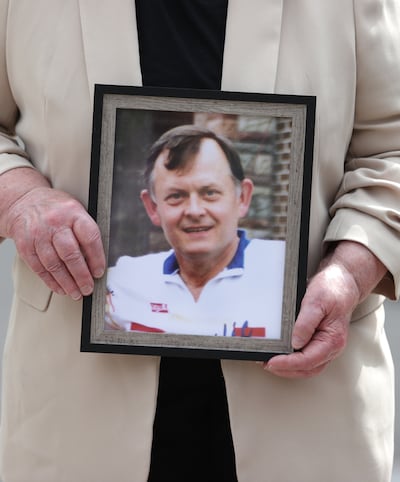 Bridie Brown, the widow of murdered GAA official Seán Brown, holds a picture of him, outside the Royal Courts of Justice in Belfast in June 2023. Photograph: Liam McBurney/PA Wire