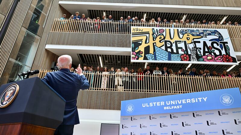 Joe Biden addresses a packed balcony above him at Ulster University. Photograph: Kenny Holston/The New York Times
                      