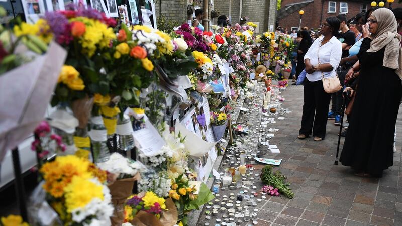 Floral tributes close to Grenfell Tower, a 24-storey apartment block in North Kensington, London that burned down this week. Photograph: Andy Rain/EPA