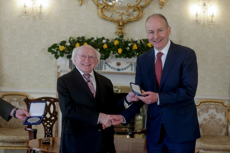 President Michael D Higgins presents the seal of office to newly elected Taoiseach Micheál Martin in Áras an Uachtaráin on Thursday. Photograph: Maxwell's/PA Wire