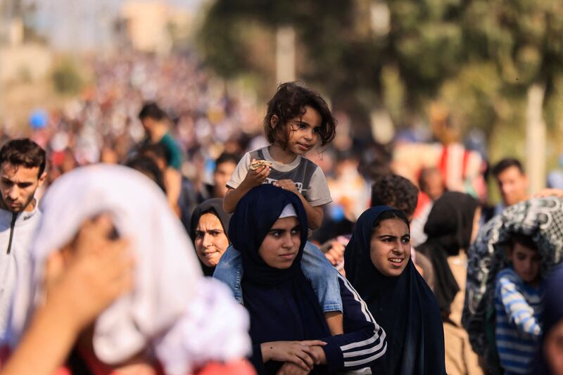 Palestinians families fleeing Gaza City and other parts of northern Gaza walk on a road towards the south of the enclave on Friday. Photograph: Mahmud Hams/AFP via Getty Images