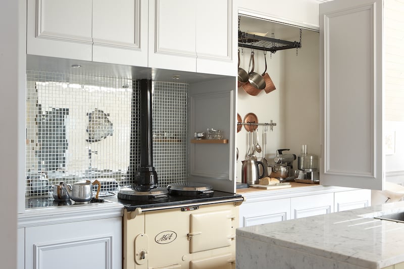 Appliance larder in Sandycove, Co Dublin home designed by interior architect Gillian Sherrard. Mirrored splashback adds interest and individuality