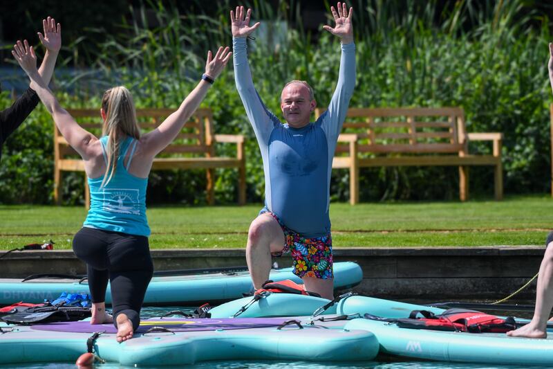 A yoga session  - on a paddleboard - in Henley-on-Thames. Photograph: Chris Ratcliffe/Bloomberg 