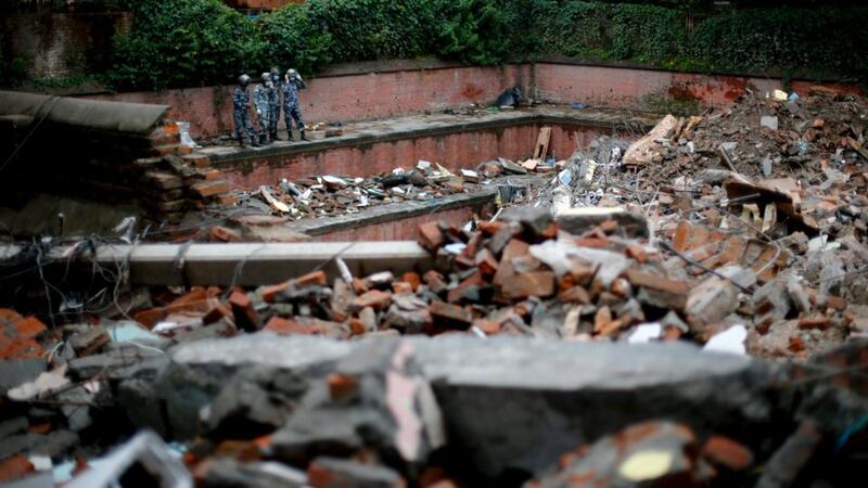 Nepalese search and rescue workers survey the rubble of a collapsed hotel in Kathmandu, Nepal. The Department of Foreign Affairs has said that it has yet to make contact with 10 Irish citizens following the disaster. Photograph: Diego Azubel/EPA