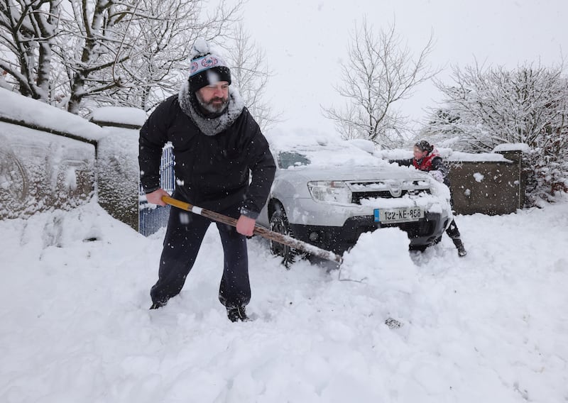 Damien Brett with his daughter Fiadh (7) clear the snow from their driveway near Castlewarren near Kilkenny City. Photograph: Alan Betson

