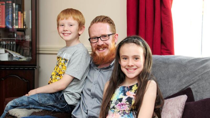 Kevin Dunne with his children Daniel (8) and Ellie (10), at their home in Portarlington, Co Laois. Photograph: James Flynn/APX Looking for savings: Kevin Dunne with his children, Daniel, who is eight, and Ellie, who is 10. Photograph: James Flynn/APX