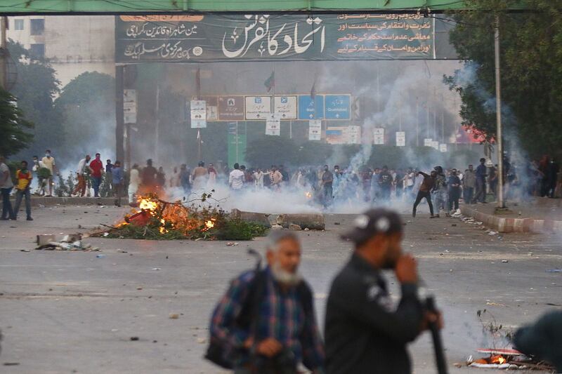 Supporters of Imran Khan clash with police during a protest against Mr Khan's arrest, in Karachi on Tuesday. Photograph: Shahzaib Akber/EPA-EFE