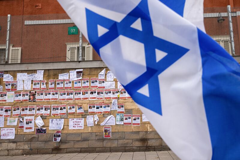 Photographs of Israelis believed to have been kidnapped by Hamas gunmen outside the offices of the Israeli ministry of defence, in Tel Aviv Photograph: Tamir Kalifa/New York Times