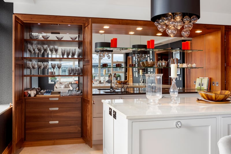 Two walnut pantries flank each side of the kitchen 