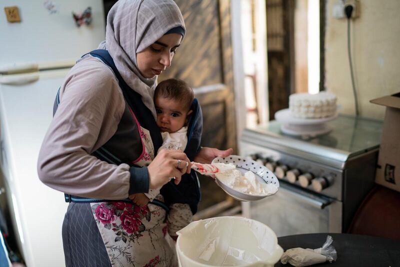 Khadija Al-Sharif bakes her first ever wedding cake at her home in the city of Hebron, Palestine. Photograph: Samar Hazboun/ActionAid