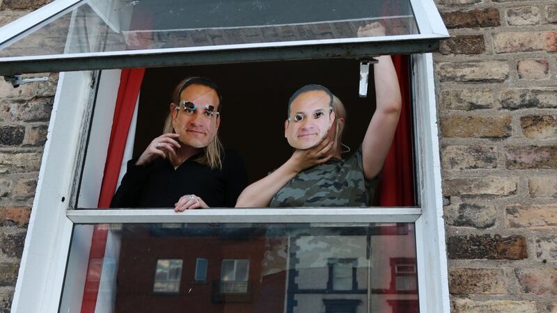 Two individuals in the home wearing Leo Varadkar face masks hung a banner with the words “Homes for All” from the second floor window of the house. Photograph:  Nick Bradshaw/Irish Times