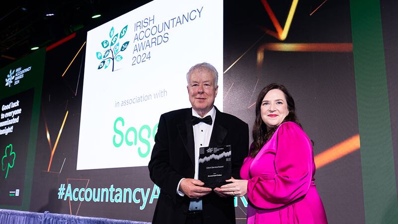 Peter Brophy, awards judge, presents the client service award to Christina McGreevy, Accountant Online