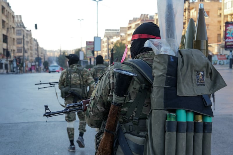 Anti-government fighters patrol in central Aleppo. Photograph: Muhammad Haj Kadour/AFP/Getty Images