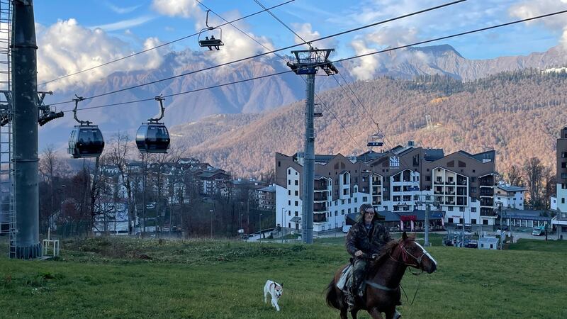 A horseman and his dog gallop beneath a cable car in Krasnaya Polyana in the Caucasus mountains, where Russia hosted the 2014 Winter Olympics. Photograph: Daniel McLaughlin