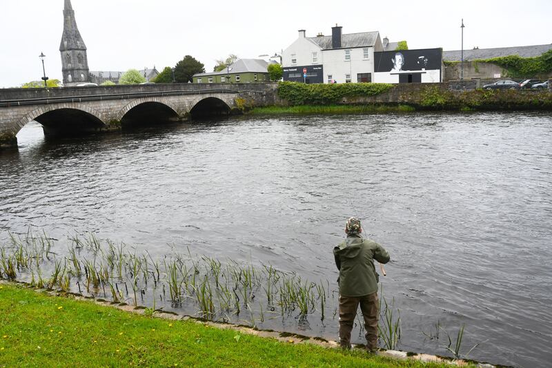 The ridge pool at Upper Bridge in Ballina, with fisherman Michael Rooney from Belfast and, in the background, a mural of Jack Charlton. Photograph: John O'Grady.