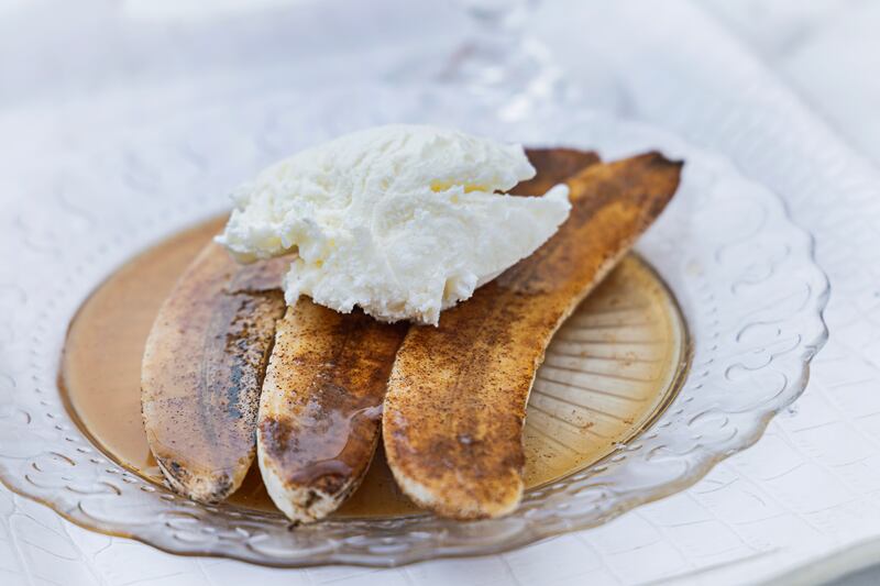 Flambeed bananas with cinnamon, rum, and vanilla ice cream. Photograph: Harry Weir Photography